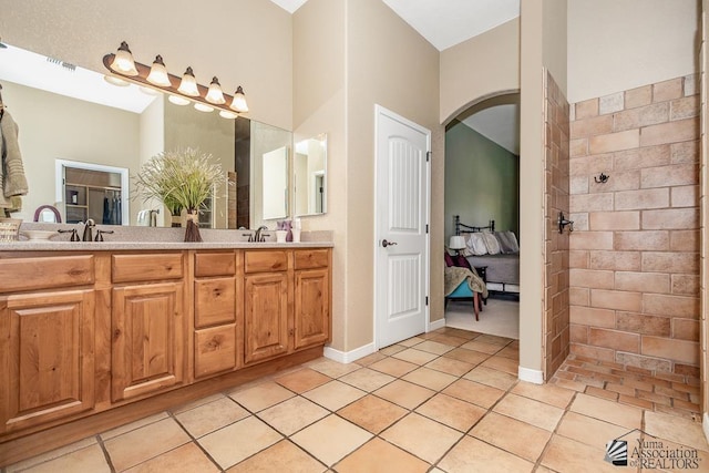 12147 E 33rd St, Yuma, AZ 85367 - bathroom with tile patterned flooring, double vanity, connected bathroom, and a tile shower