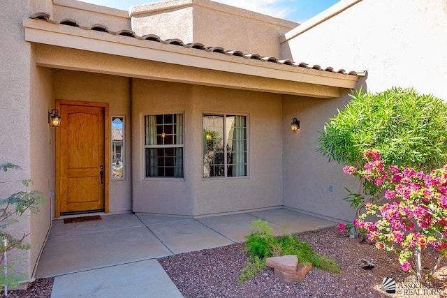 12147 E 33rd St, Yuma, AZ 85367 - entrance to property featuring a patio, stucco siding, and a tiled roof