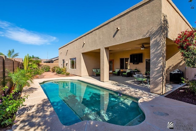 12147 E 33rd St, Yuma, AZ 85367 - view of swimming pool with ceiling fan, outdoor lounge area, a fenced backyard, a fenced in pool, and a patio