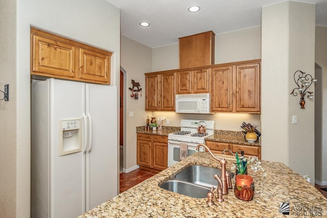 12147 E 33rd St, Yuma, AZ 85367 - kitchen with dark tile patterned floors, a sink, light stone counters, baseboards, and white appliances