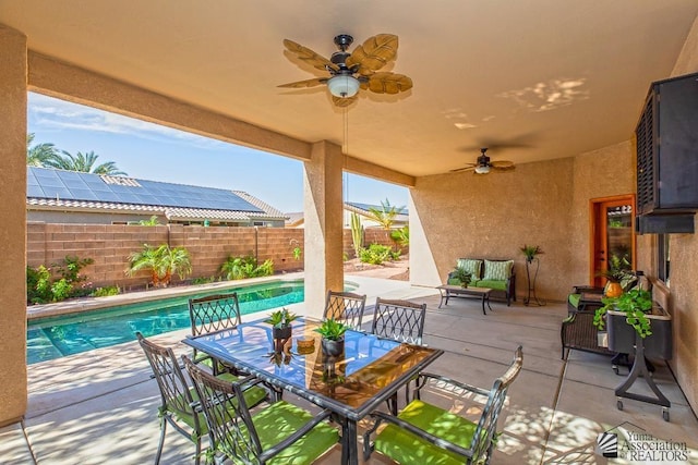 12147 E 33rd St, Yuma, AZ 85367 - view of patio with a fenced in pool, a fenced backyard, ceiling fan, and outdoor dining space