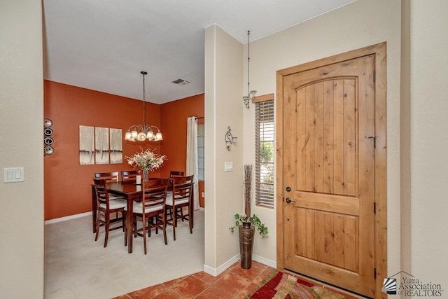 12147 E 33rd St, Yuma, AZ 85367 - foyer featuring visible vents, carpet, baseboards, and an inviting chandelier