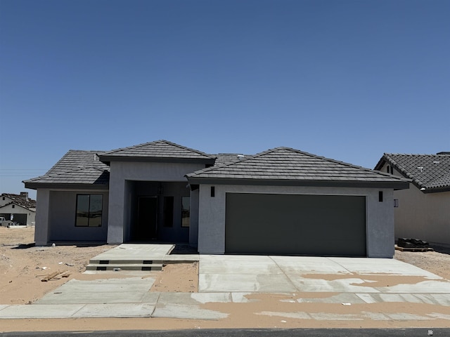 10802 E 45th Ln, Yuma, AZ 85367 - view of front of house with an attached garage, concrete driveway, stucco siding, and a tiled roof