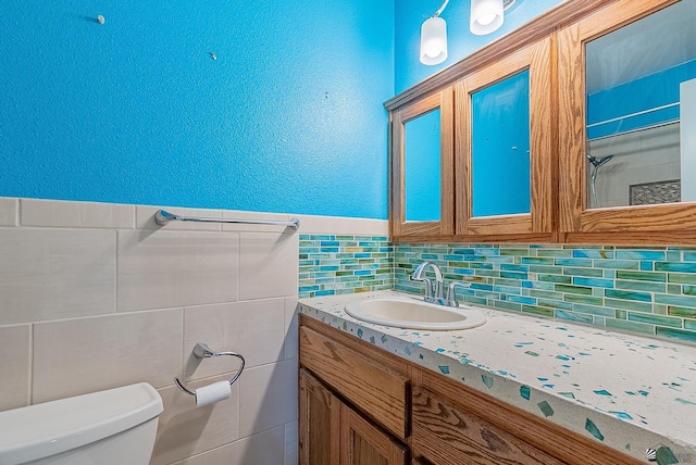 1221 S 10th Ave, Yuma, AZ 85364 - full bathroom with vanity, tile walls, a shower, and tasteful backsplash