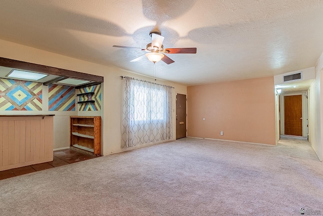 1221 S 10th Ave, Yuma, AZ 85364 - empty room featuring carpet, a ceiling fan, and a textured ceiling