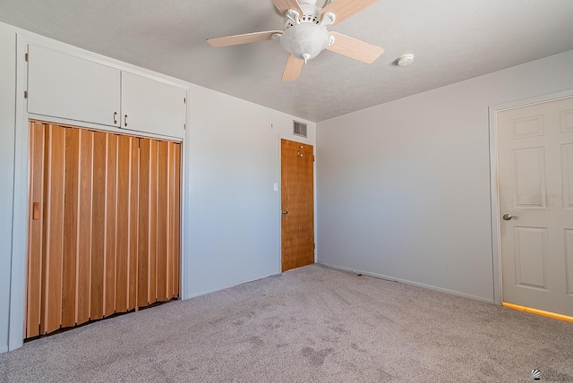 1221 S 10th Ave, Yuma, AZ 85364 - unfurnished bedroom with carpet floors, a closet, ceiling fan, and a textured ceiling