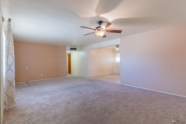 1221 S 10th Ave, Yuma, AZ 85364 - unfurnished room with a ceiling fan, light carpet, and a textured ceiling