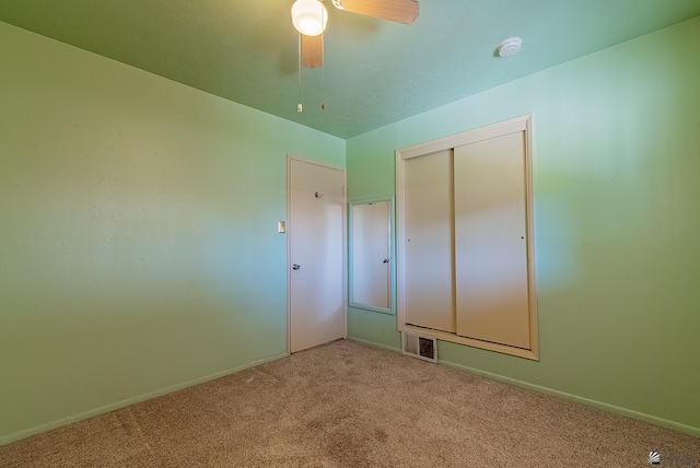 1221 S 10th Ave, Yuma, AZ 85364 - unfurnished bedroom featuring carpet flooring, a closet, and a ceiling fan