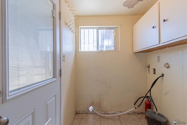1221 S 10th Ave, Yuma, AZ 85364 - washroom with cabinet space, hookup for a washing machine, and light tile patterned floors