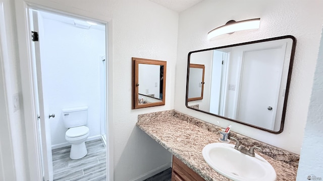 1766 W Camino Kino, Yuma, AZ 85364 - full bath with toilet, vanity, wood finished floors, and baseboards