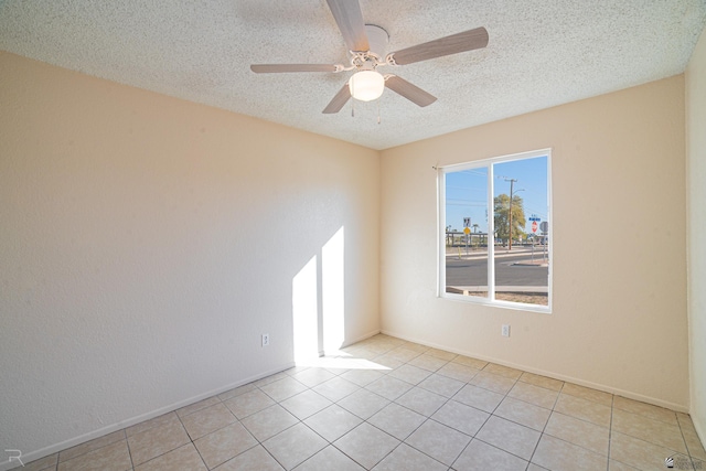 tiled spare room featuring ceiling fan and a textured ceiling