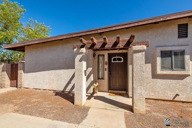 1465 E Laguna Pl Unit 4, Yuma, AZ 85365 - entrance to property with a pergola, fence, and stucco siding