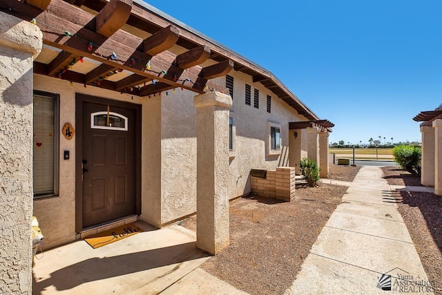 1465 E Laguna Pl Unit 4, Yuma, AZ 85365 - property entrance with a pergola and stucco siding