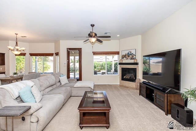 3674 W 39th St, Yuma, AZ 85365 - carpeted living area with a tiled fireplace, baseboards, ceiling fan with notable chandelier, and visible vents