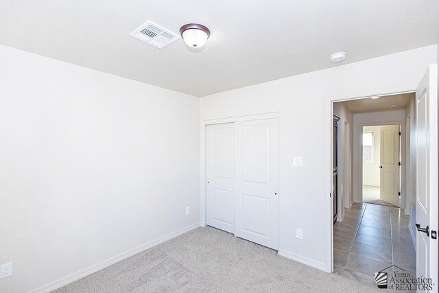 12663 E 51st Pl, Yuma, AZ 85367 - unfurnished bedroom featuring a closet, baseboards, and carpet floors