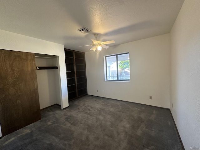 11651 E Via Salida, Yuma, AZ 85367 - unfurnished bedroom featuring a ceiling fan, visible vents, and dark colored carpet
