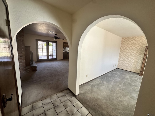 11651 E Via Salida, Yuma, AZ 85367 - carpeted empty room featuring visible vents, a ceiling fan, arched walkways, and tile patterned floors