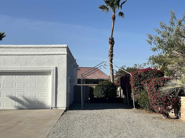 11651 E Via Salida, Yuma, AZ 85367 - view of home's exterior featuring stucco siding, an attached garage, and driveway
