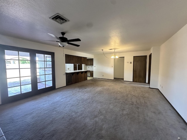 11651 E Via Salida, Yuma, AZ 85367 - unfurnished living room with baseboards, visible vents, ceiling fan with notable chandelier, and dark colored carpet