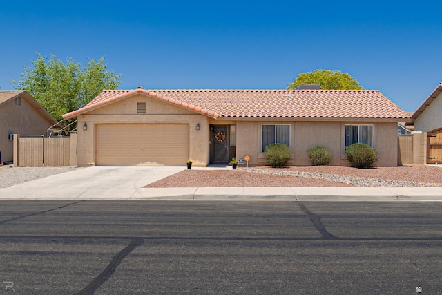 6340 E 45th Pl, Yuma, AZ 85365 - view of front of home with stucco siding, a tiled roof, an attached garage, and driveway