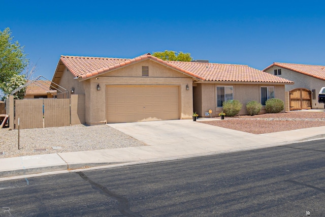 6340 E 45th Pl, Yuma, AZ 85365 - mediterranean / spanish home with a gate, stucco siding, a tile roof, and an attached garage