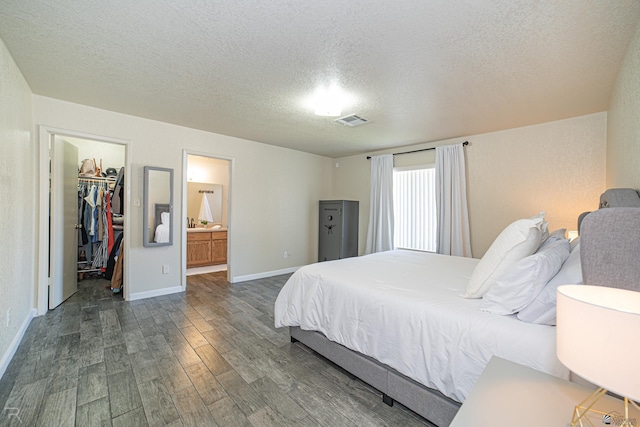 6340 E 45th Pl, Yuma, AZ 85365 - bedroom with dark wood finished floors, a textured ceiling, a spacious closet, baseboards, and a closet