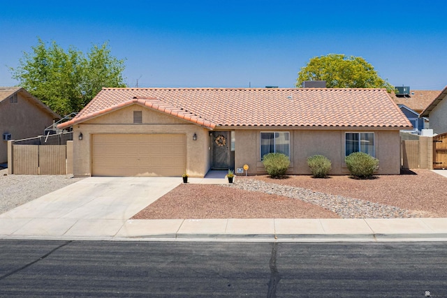 6340 E 45th Pl, Yuma, AZ 85365 - view of front of property featuring a tile roof, stucco siding, a garage, and concrete driveway