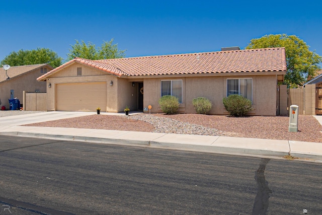 6340 E 45th Pl, Yuma, AZ 85365 - view of front facade with stucco siding, a tiled roof, an attached garage, and concrete driveway