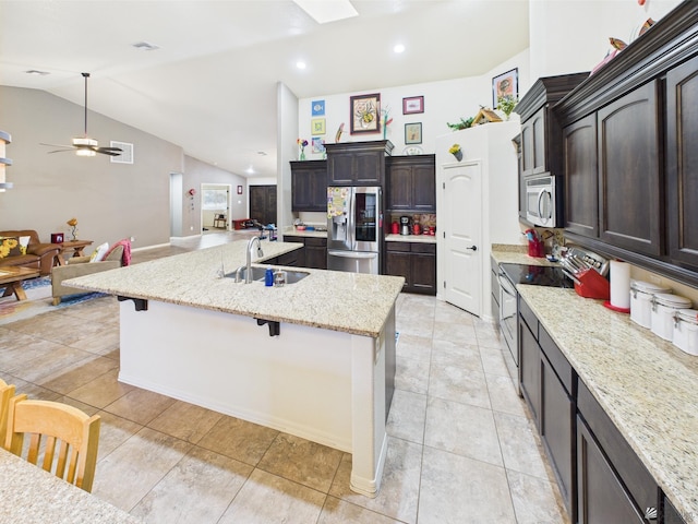 5936 E 39th St, Yuma, AZ 85365 - kitchen with appliances with stainless steel finishes, a sink, a large island with sink, open floor plan, and lofted ceiling