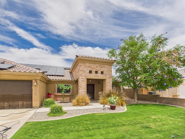 5936 E 39th St, Yuma, AZ 85365 - view of front of property featuring a tiled roof, solar panels, a front lawn, stucco siding, and stone siding