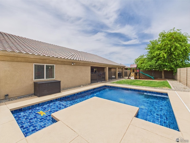5936 E 39th St, Yuma, AZ 85365 - view of pool featuring a fenced backyard, a playground, and a patio