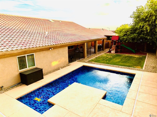 5936 E 39th St, Yuma, AZ 85365 - view of swimming pool featuring a playground, a yard, and a patio