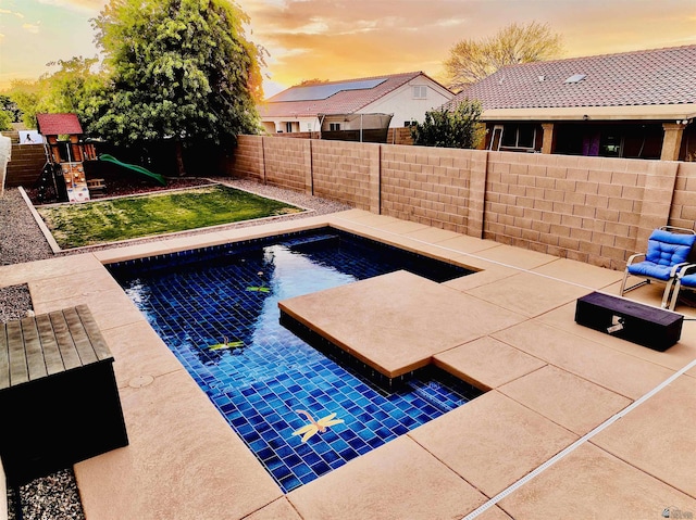5936 E 39th St, Yuma, AZ 85365 - pool at dusk with a playground and a patio