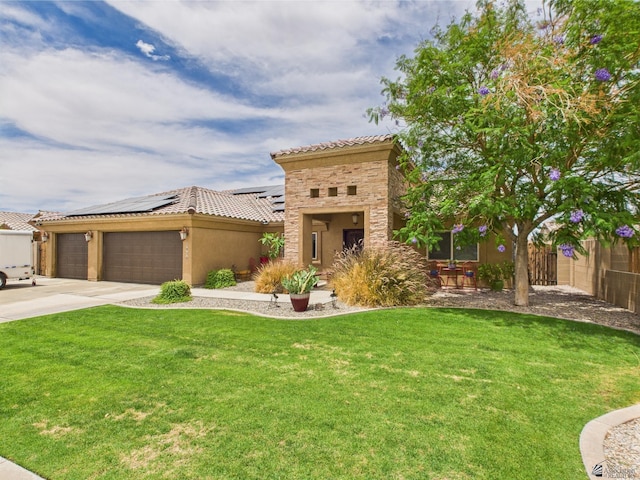 5936 E 39th St, Yuma, AZ 85365 - mediterranean / spanish house featuring a tiled roof, solar panels, a garage, and concrete driveway