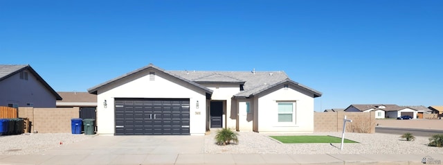 ranch-style home featuring an attached garage, stucco siding, fence, and driveway