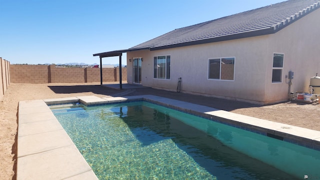 view of swimming pool with a fenced backyard, a fenced in pool, and a patio area