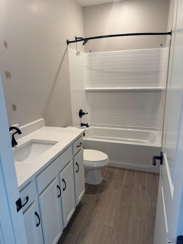 full bathroom featuring wood tiled floor, vanity, toilet, and bathing tub / shower combination
