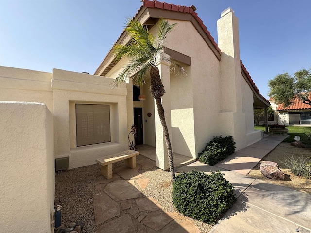 10193 S Del Rey Dr, Yuma, AZ 85367 - entrance to property featuring a tiled roof, a chimney, and stucco siding