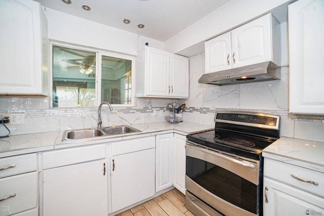 12687 E 42nd Pl, Yuma, AZ 85367 - kitchen featuring a sink, under cabinet range hood, white cabinetry, and electric stove