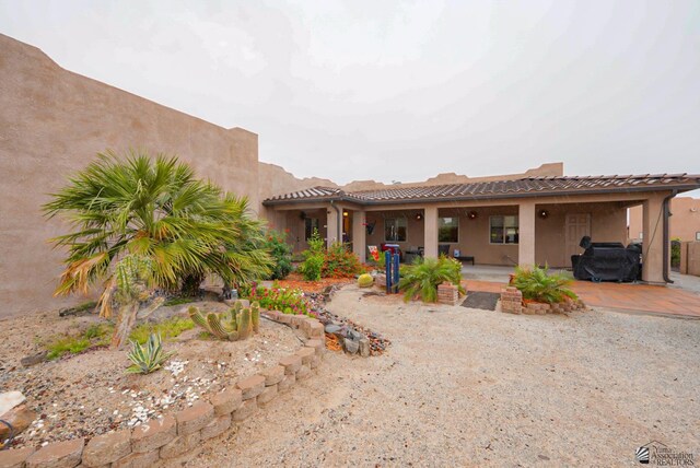 12806 E 49th Dr, Yuma, AZ 85367 - adobe home with a tiled roof, a patio area, and stucco siding