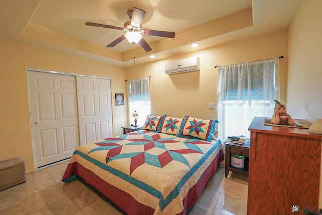 12806 E 49th Dr, Yuma, AZ 85367 - bedroom featuring a closet, a raised ceiling, light tile patterned floors, and a wall mounted AC