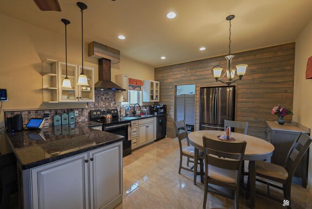 12806 E 49th Dr, Yuma, AZ 85367 - kitchen with wall chimney range hood, black electric range, freestanding refrigerator, dishwashing machine, and wooden walls