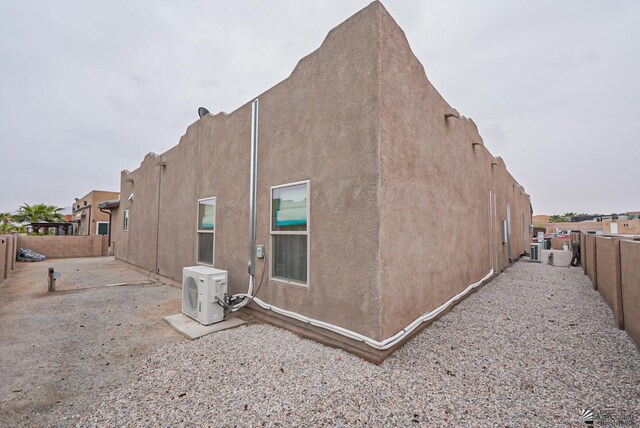 12806 E 49th Dr, Yuma, AZ 85367 - view of side of property featuring a fenced backyard, ac unit, and stucco siding
