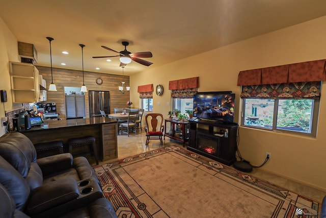 12806 E 49th Dr, Yuma, AZ 85367 - living room with wooden walls, a ceiling fan, baseboards, and recessed lighting