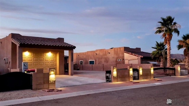 12806 E 49th Dr, Yuma, AZ 85367 - view of front of property with fence, stucco siding, a gate, concrete driveway, and a tiled roof