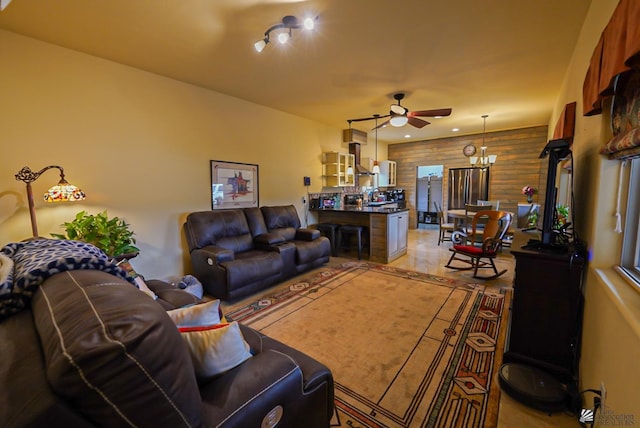 12806 E 49th Dr, Yuma, AZ 85367 - living room featuring a ceiling fan and wood walls