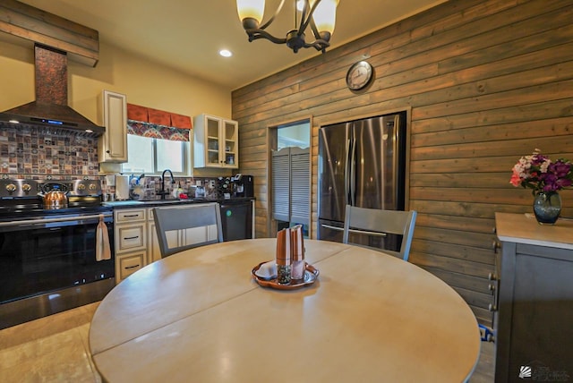 12806 E 49th Dr, Yuma, AZ 85367 - kitchen featuring backsplash, appliances with stainless steel finishes, a chandelier, recessed lighting, and wall chimney exhaust hood
