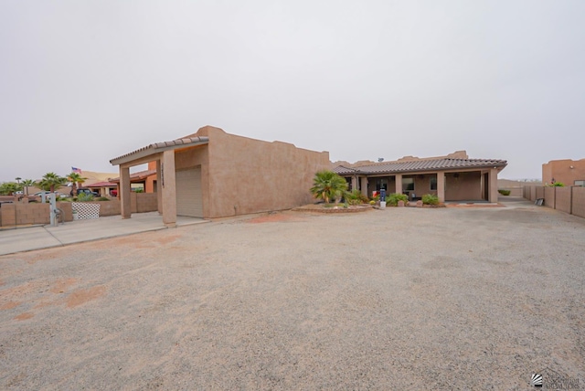 12806 E 49th Dr, Yuma, AZ 85367 - adobe home featuring fence, stucco siding, a tiled roof, concrete driveway, and an attached garage