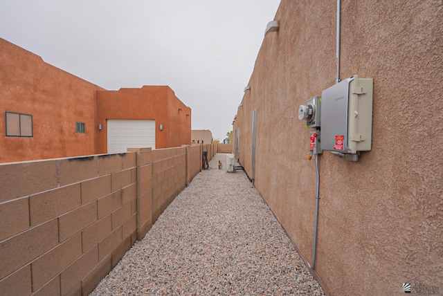 12806 E 49th Dr, Yuma, AZ 85367 - view of side of property with fence, stucco siding, and a garage