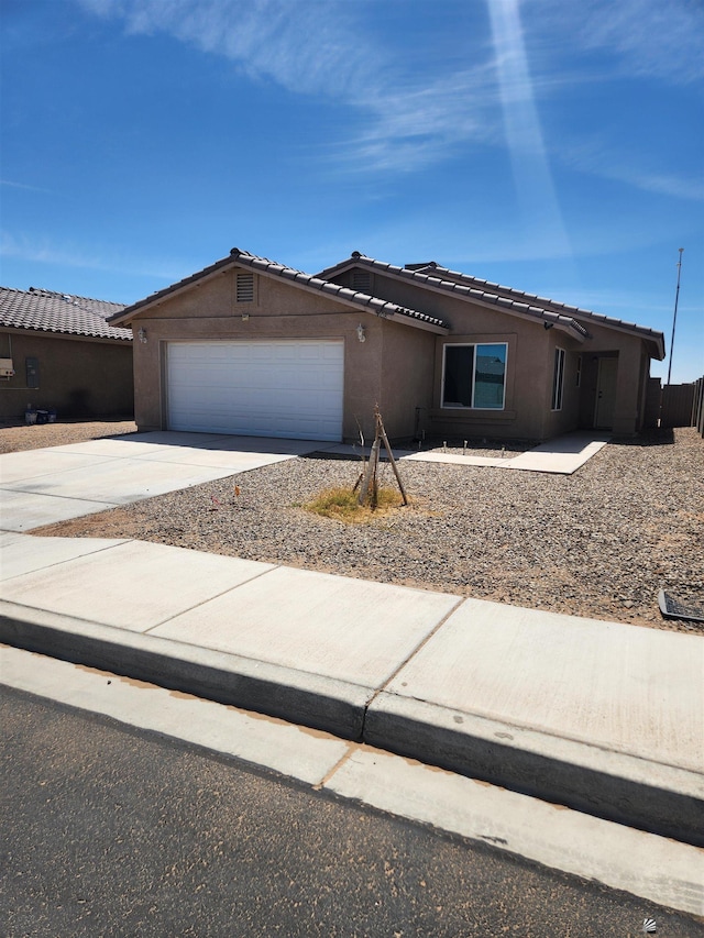3708 S Desert Oasis Dr, Yuma, AZ 85365 - ranch-style house with an attached garage, stucco siding, driveway, and a tile roof